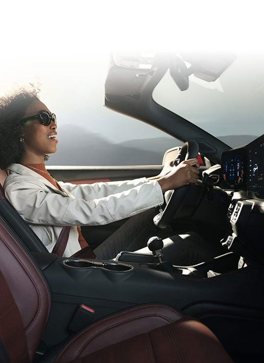 Person sitting in the driver’s seat of a 2024 Ford Mustang® convertible | Al Packer Ford West Palm Beach in West Palm Beach FL
